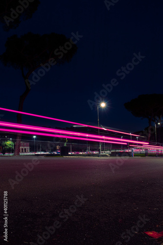  fast-moving car at night. Rome, Italy. low wide angle, long exposure photography technique.