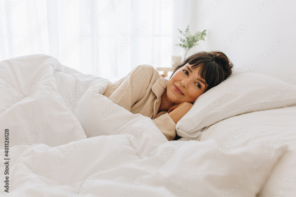 Woman lying on bed at home Woman lying on bed at home