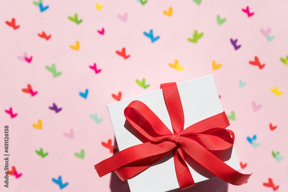 top view of decoration valentine's day background concept.Flat lay arrangement of colorful shape and gift box on pink paper.Valentine's day or love concept. World Women's Day holiday card concept. top view of decoration valentine's day background concept.Flat lay arrangement of colorful shape and gift box on pink paper.Valentine's day or love concept. World Women's Day holiday card concept.