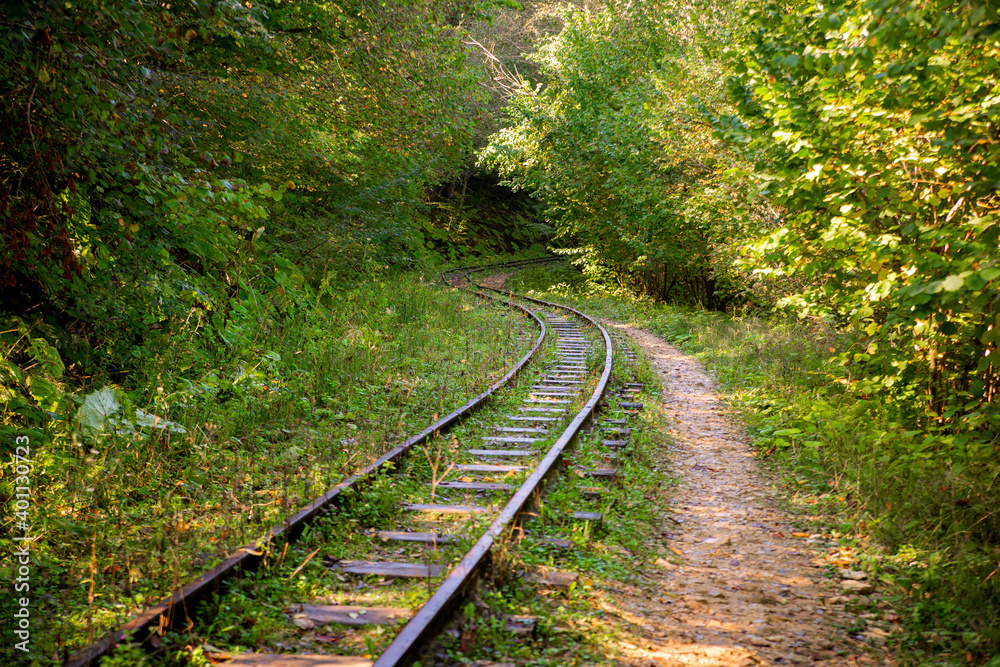 Abandoned railway in autumn mountain forest with foliar trees in Caucasus, Mezmay Abandoned railway in autumn mountain forest with foliar trees in Caucasus, Mezmay