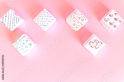 Composition of holiday white gift boxes with red hearts on pink background. Happy Valentine's Day, Mother's Day, World Women's Day holiday card concept. Flat lay.Copy space