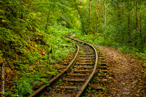 Abandoned railway in autumn mountain forest with foliar trees in Caucasus, Mezmay photo