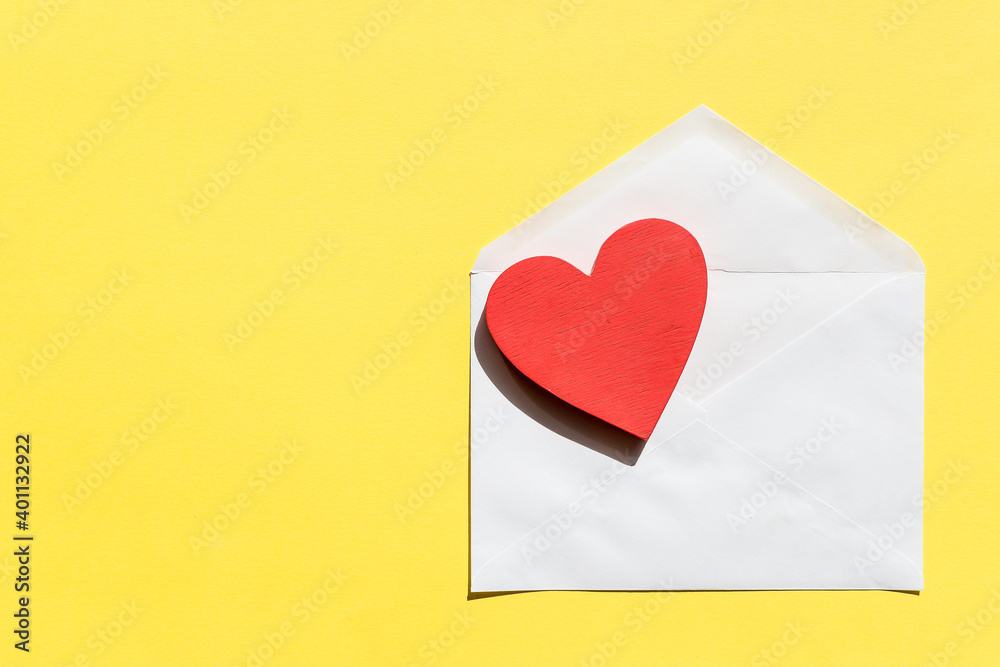 Opened envelope and red heart.Creative design for packaging, blogger.Happy birthday, wedding, Valentine's day concept of greetings. Copy space. Opened envelope and red heart.Creative design for packaging, blogger.Happy birthday, wedding, Valentine's day concept of greetings. Copy space.
