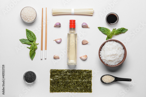 Composition with rice vinegar  on light background photo