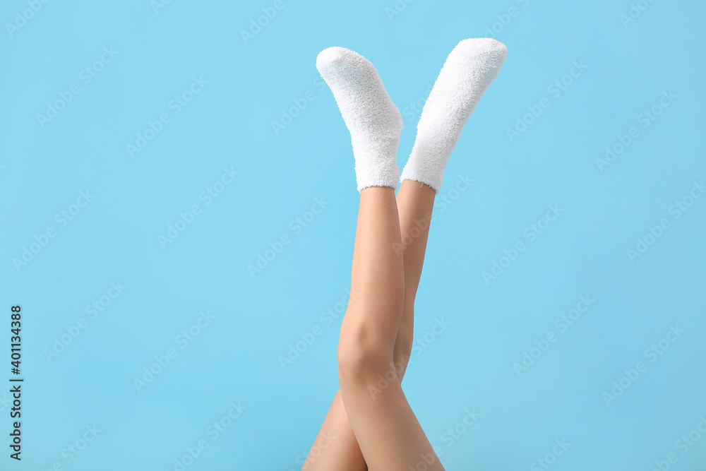 Legs of young woman in socks on color background Legs of young woman in socks on color background