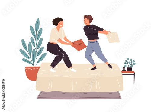 Adorable woman friends playing pillow fight on bed vector flat illustration. ...