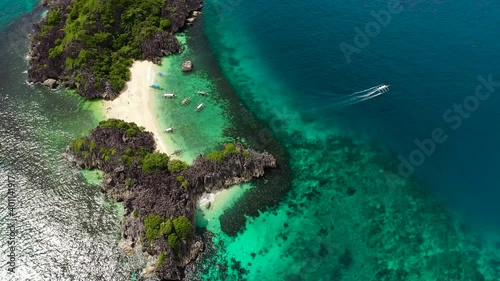 Tropical landscape: Lahos Island with beautiful beach and tourists by turquoise water view from above. Caramoan Islands, Philippines. Summer and travel vacation concept. photo