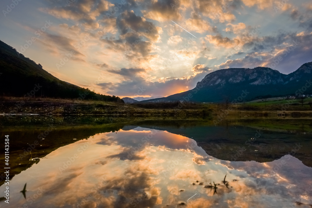 beautiful reflection from the landscape with mountains and clouds on the sky in the water