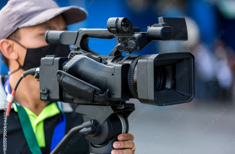 Video camera operator working with his equipment. video cinema production. Covering an event with a video camera. Professional video man hand holding camera operator camcorder working. Video camera operator working with his equipment. video cinema production. Covering an event with a video camera. Professional video man hand holding camera operator camcorder working.