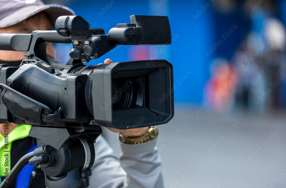 Video camera operator working with his equipment. video cinema production. Covering an event with a video camera. Professional video man hand holding camera operator camcorder working. Video camera operator working with his equipment. video cinema production. Covering an event with a video camera. Professional video man hand holding camera operator camcorder working.
