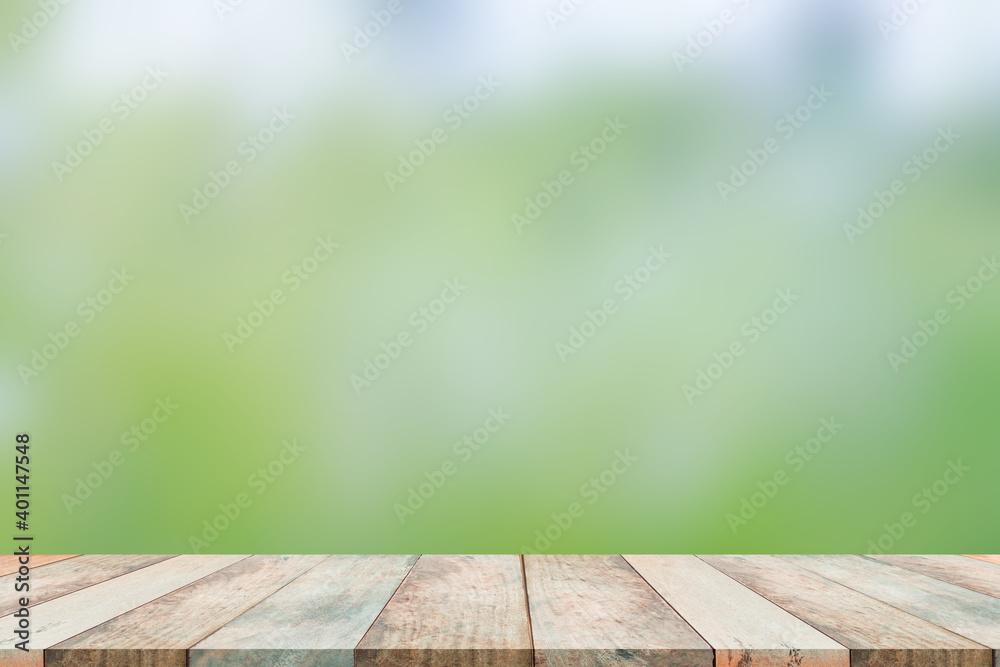 Wood table on blur green background. blank wood perspective on blur green nature for add text. 