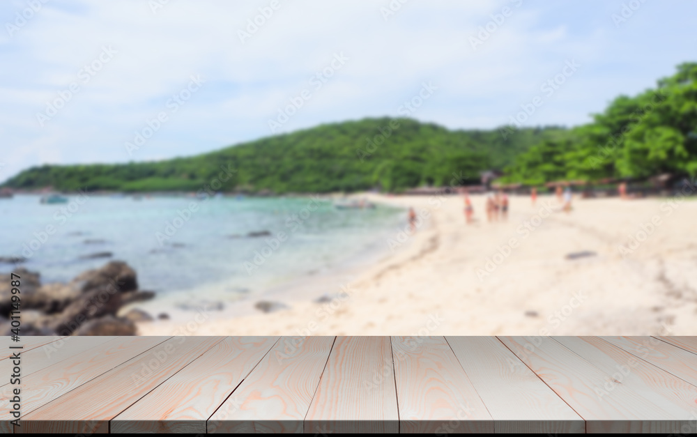 Fototapeta premium Wood perspective on blue sea and beach blur image background. wood table top on blurred blue sea. thai sea concept.