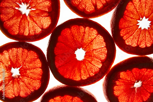 Silhouettes. Colorful creative background of grapefruit slices. Flat lay macro close-up, top view