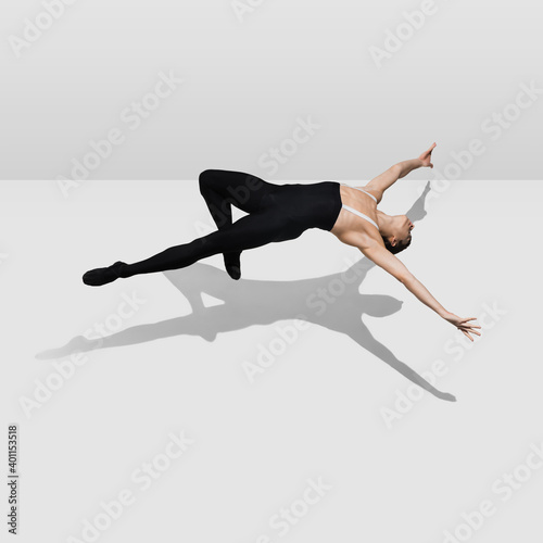 Free falling. Stylish young male athlete on white studio background with shadows in jump, air flying. Sportive fit model in motion and action. Body building, healthy lifestyle, style concept.