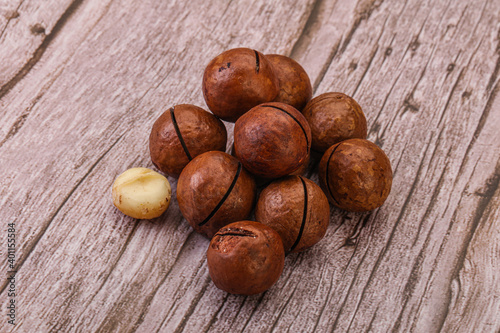 Brown macadamia nut heap over background