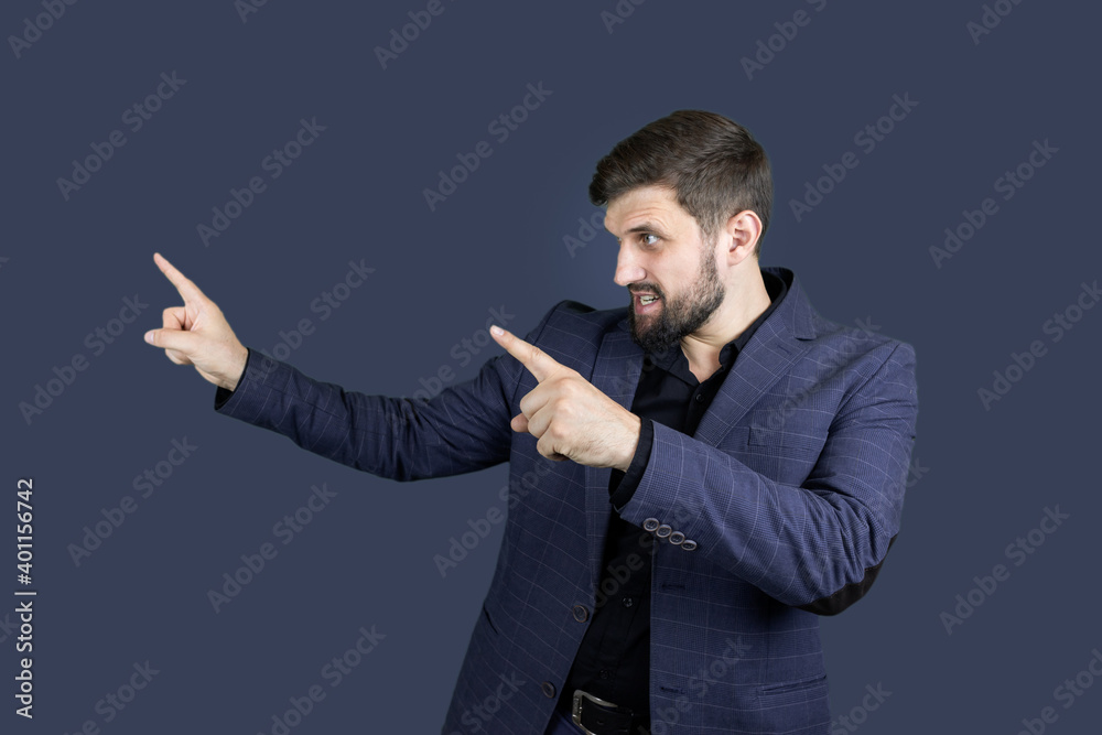 a businessman a man with a beard and a blue suit shows the direction with both hands a businessman a man with a beard and a blue suit shows the direction with both hands