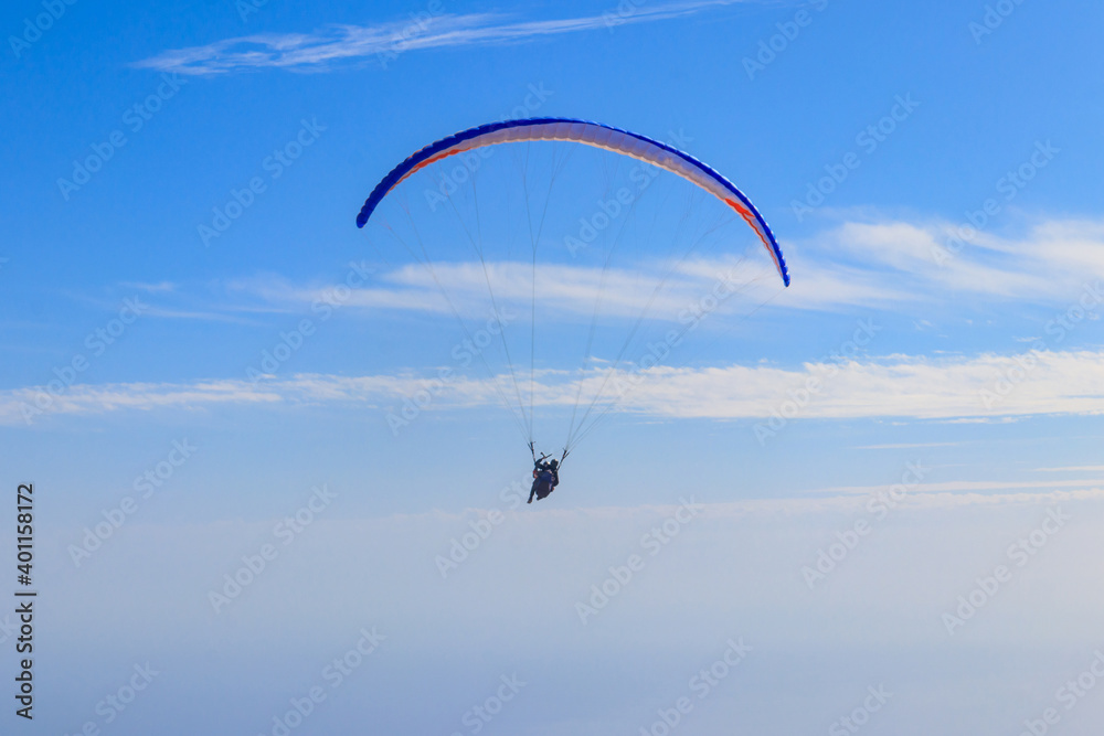 Paragliders in blue sky. Concept of active lifestyle and extreme sport adventure Paragliders in blue sky. Concept of active lifestyle and extreme sport adventure
