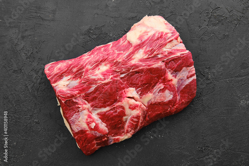 Raw fresh beef chuck center roast on black background