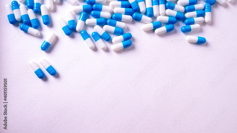 white and blue pills on white background