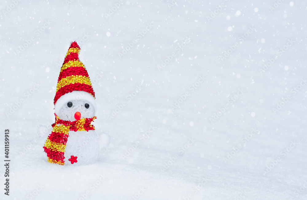 snowman in a red hat and scarf, in the snow in winter