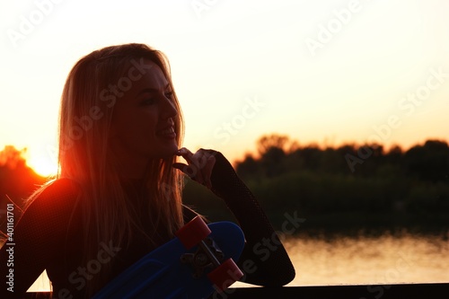 Sporty lady posing in front of misty river sunset