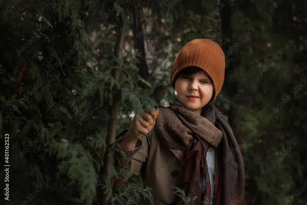 Little boy is walking through the forest, a child explores wildlife, a kid stands alone among the trees Little boy is walking through the forest, a child explores wildlife, a kid stands alone among the trees