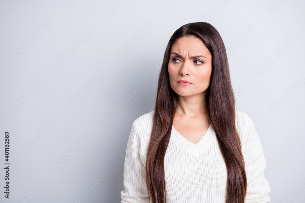 Photo of mature serious unhappy upset negative stressed woman look copyspace isolated on grey color background Photo of mature serious unhappy upset negative stressed woman look copyspace isolated on grey color background