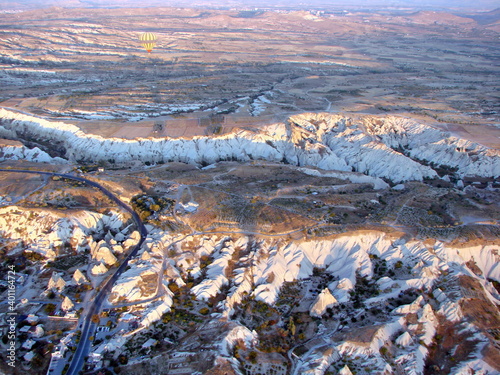 Panorama from above of mountain ranges, snow-white tops of which illuminate the first rays of sunrise.