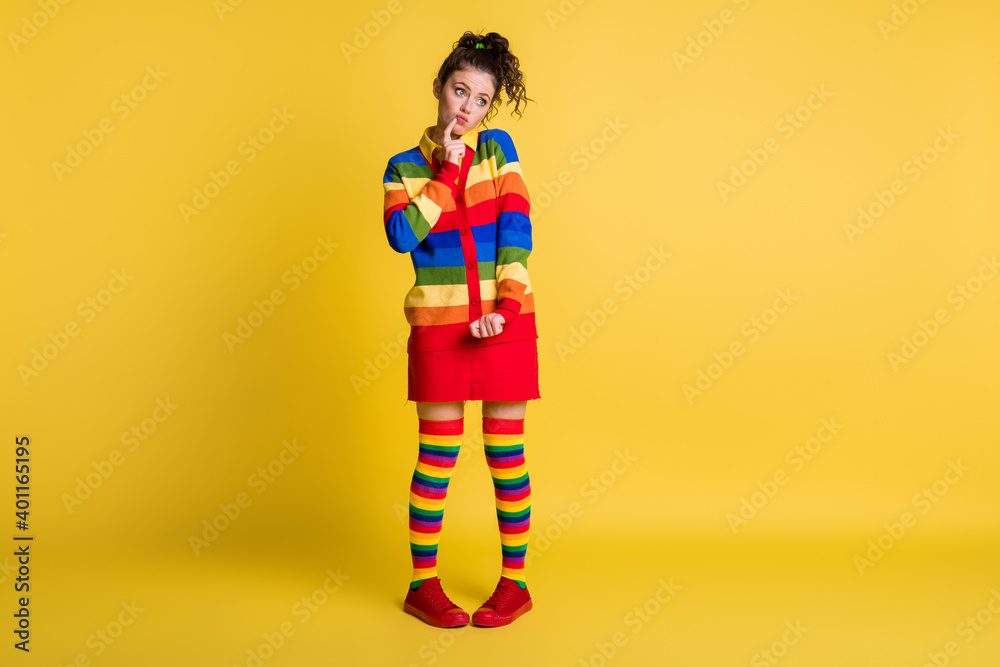 Full length photo of foolish lady playful mood slim shape wear striped sweater short skirt knee socks shoes isolated yellow color background Full length photo of foolish lady playful mood slim shape wear striped sweater short skirt knee socks shoes isolated yellow color background