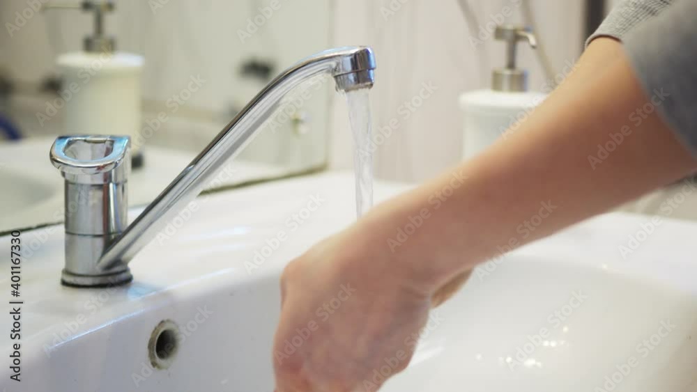 Person washing hands with soap. Concept of health, cleaning and preventing germs and coronavirus from contacting hands Person washing hands with soap. Concept of health, cleaning and preventing germs and coronavirus from contacting hands