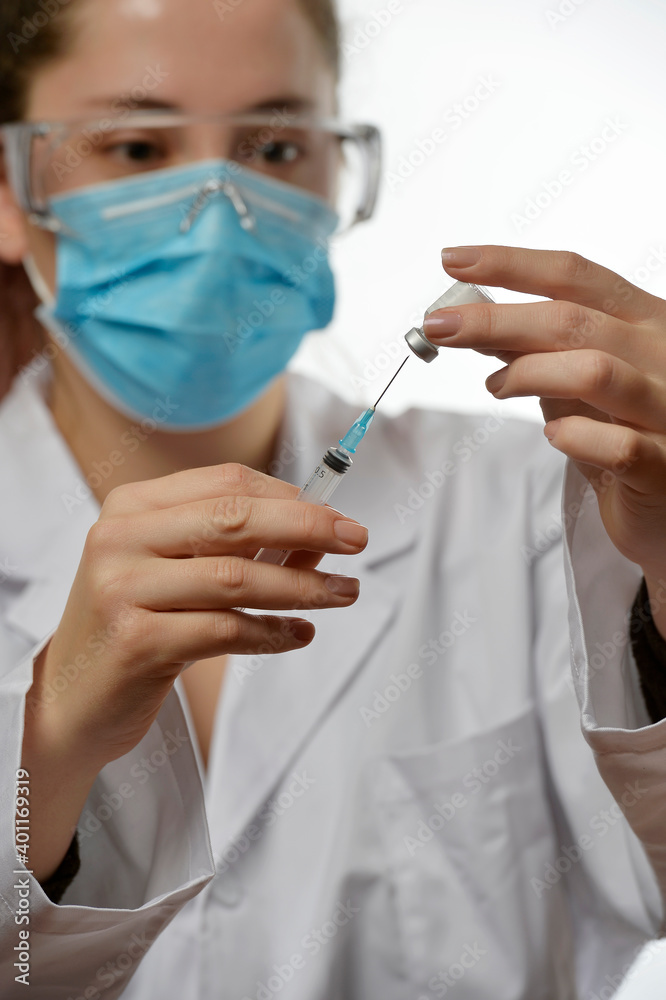 Doctor or scientist hand with vaccine vial and syringe with needle
Doctor or scientist hand with vaccine vial and syringe with needle