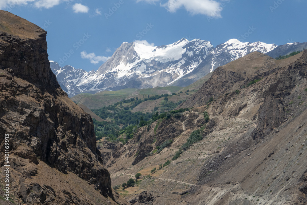 Epic landscape view of snow-capped mountains in the Panj river valley along the Pamir Highway, Darvaz district, Gorno-Badakshan, Tajikistan