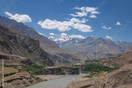 Beautiful landscape view of the Panj river valley with snow-capped mountains in background, Darvaz district, Gorno-Badakshan, the Pamir region of Tajikistan