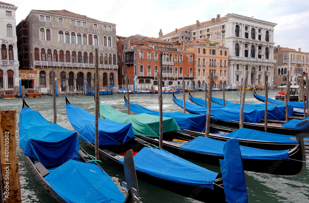 Panorama on the Grand Canal with the gondolas parked and covered with blue protections. 