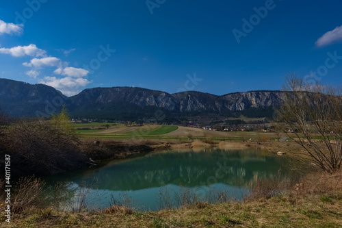 reflection from long rocky mountain range in a pond and landscape in the spring