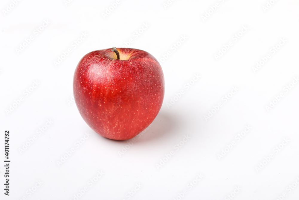 Water drop on fresh red apple on white background