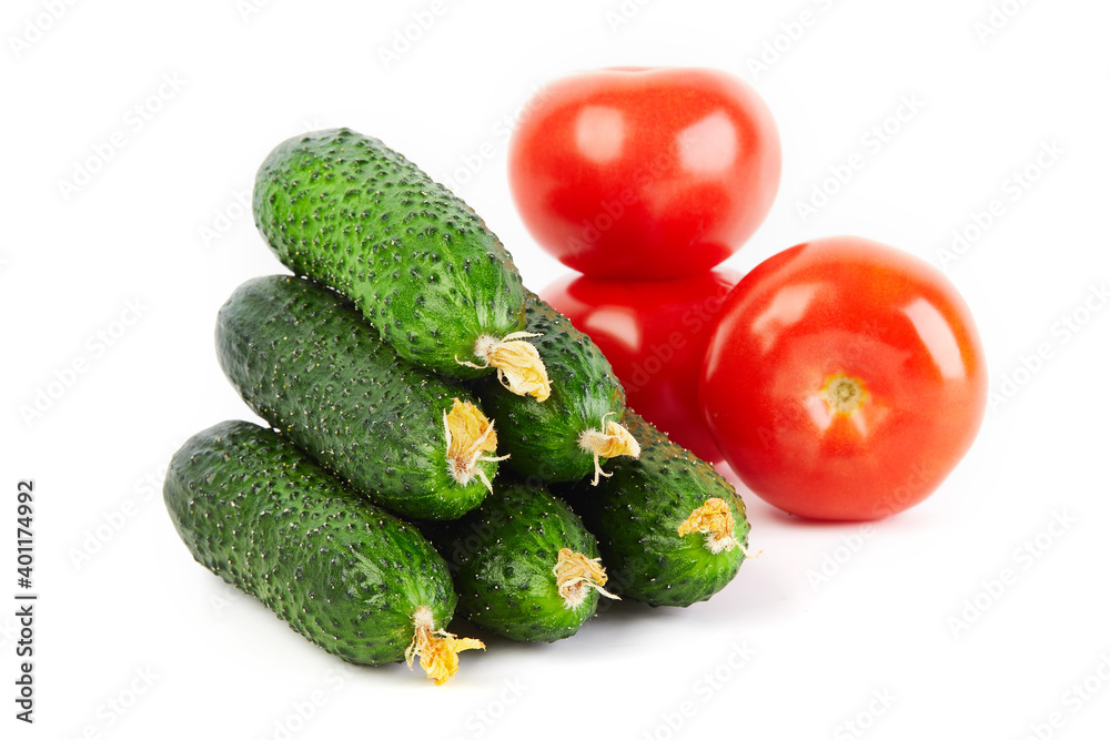 Fresh vegetables: cucumbers and tomatoes isolated on white background macro close up. Fresh vegetables: cucumbers and tomatoes isolated on white background macro close up.