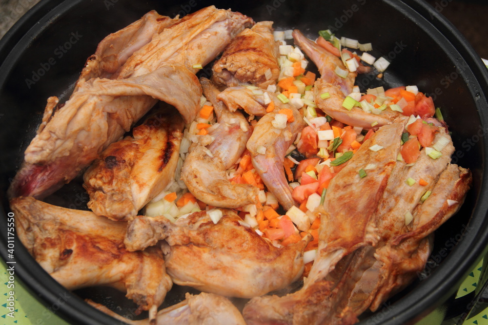 Rabbit fried in a pan with carrot and onion Rabbit fried in a pan with carrot and onion