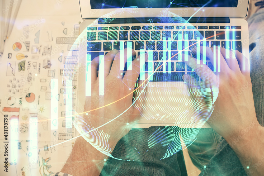 Double exposure of man's hands typing over laptop keyboard and forex chart hologram drawing. Top view. Financial markets concept. Double exposure of man's hands typing over laptop keyboard and forex chart hologram drawing. Top view. Financial markets concept.
