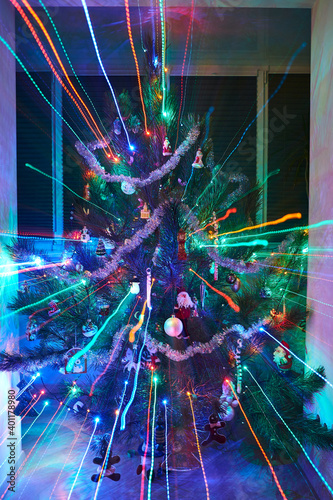 Decorated Christmas tree with neon light. Focus change effect. Christmas toys. © Pihuliak
