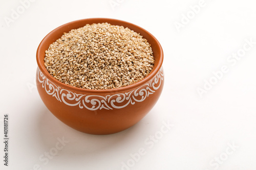 Sesame seed in bowl on white background © Niks Ads