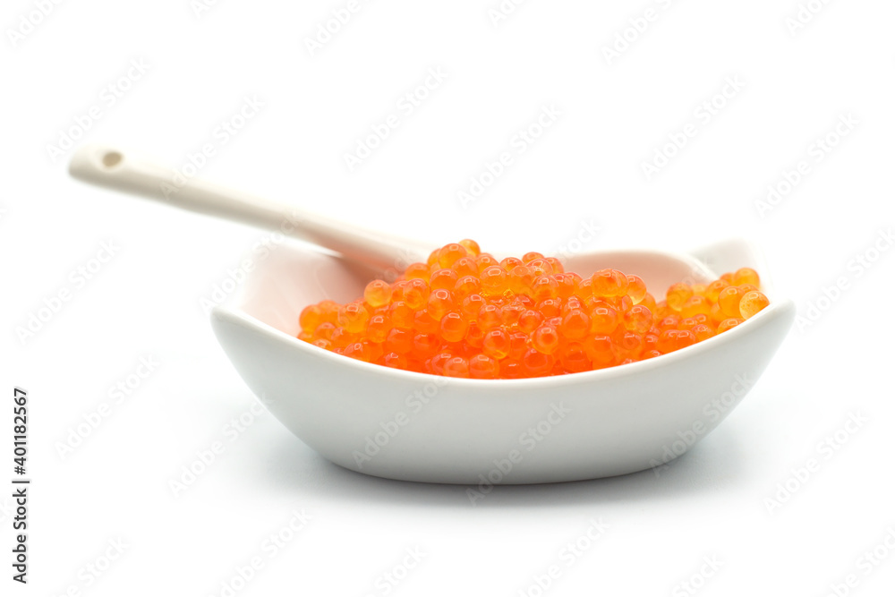 Closeup of trout eggs in a white ceramic bowl on white background
