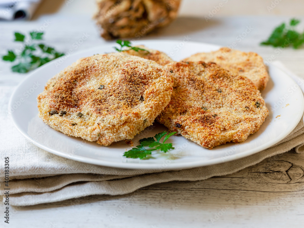 Celeriac cutlet on a white plate. Vegan food Celeriac cutlet on a white plate. Vegan food