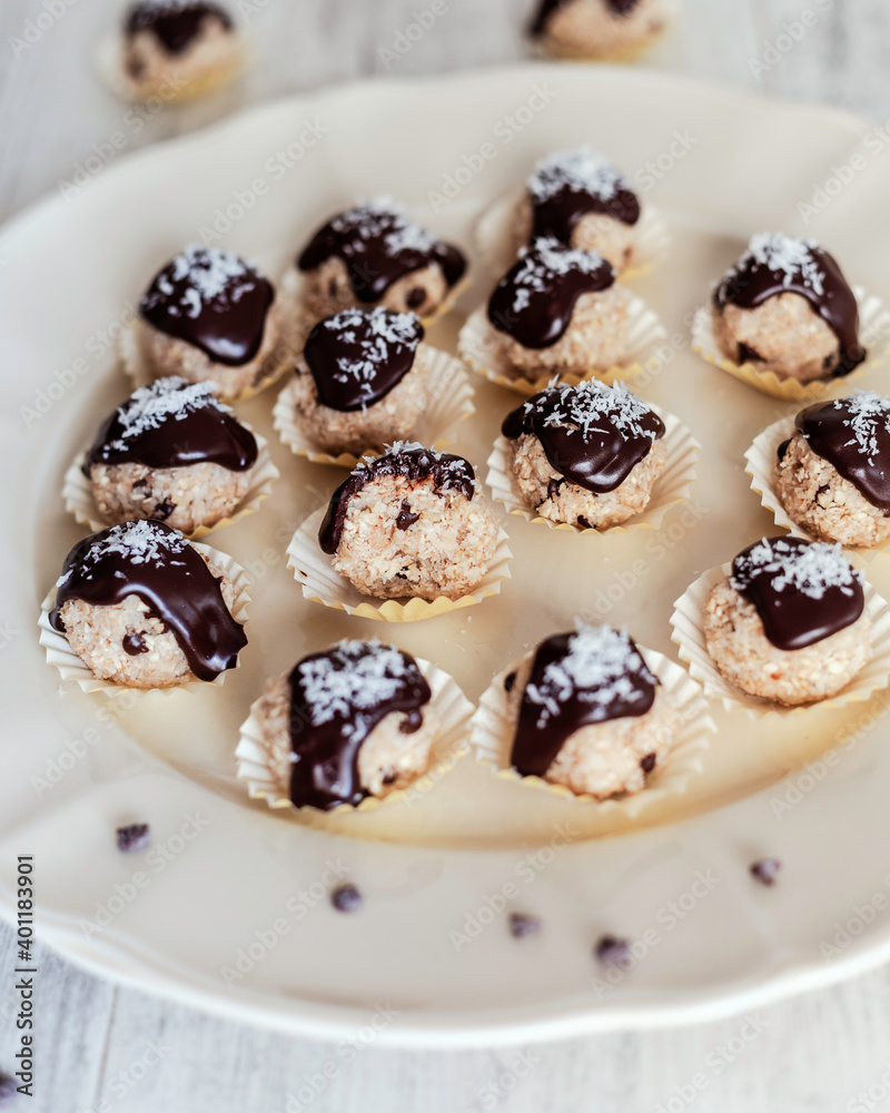 Coconut balls covered with dark chocolate Coconut balls covered with dark chocolate