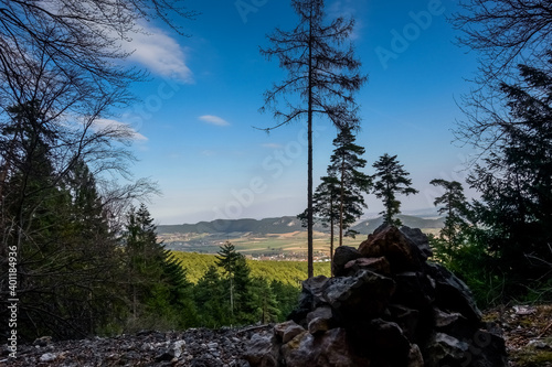 stone hill and trees with wide view while hiking