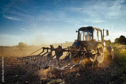 Fototapeta Naklejka Na Ścianę i Meble -  The tractor plows the land. Agriculture image
