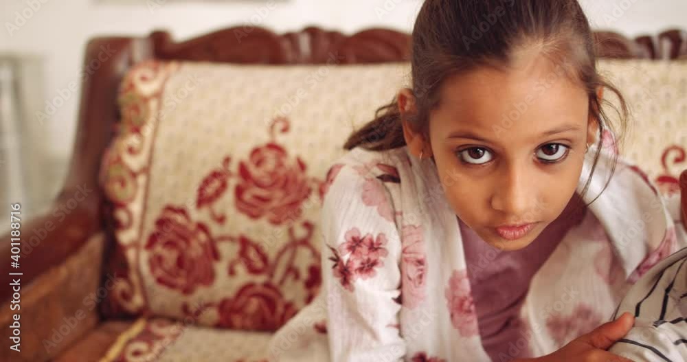 Slow-motion close of a boy and a girl share smart technology communication digital device using laptop computer tablet for education home work wifi internet learning and looking at camera pov