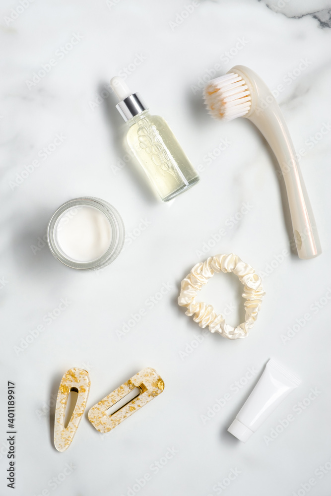 Set of body care cosmetics and feminine accessories on the marble table. Flat lay, top view.