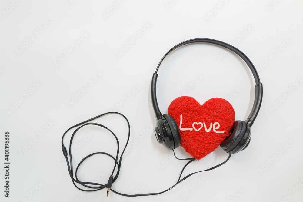 Music headphones and  red heart shape on a white background,The concept of listening to love songs