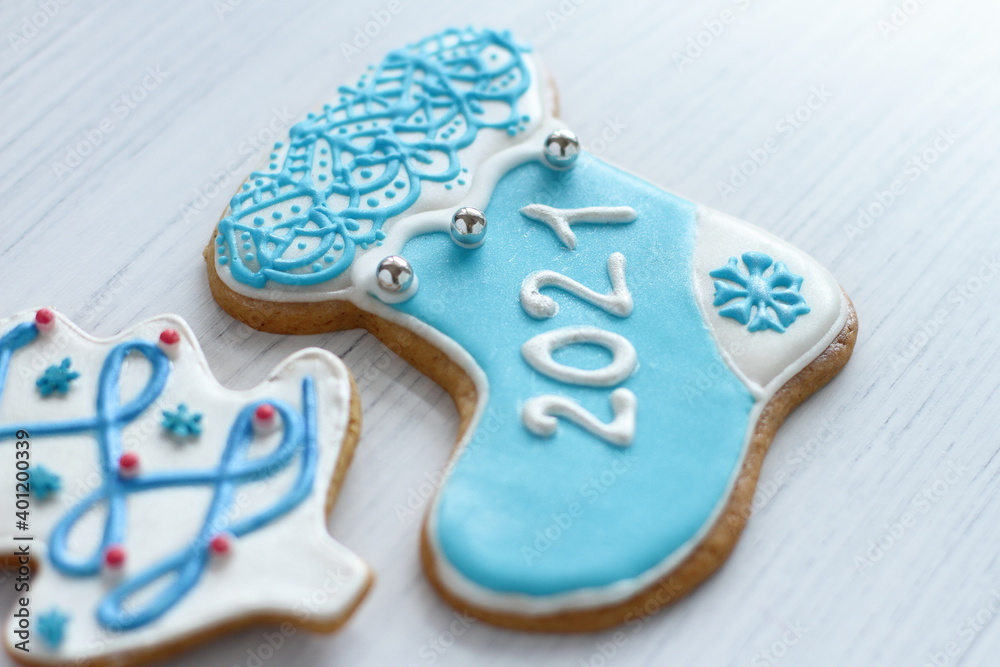 Homemade gingerbread 2021, sweet home pastry for Christmas and New Year, Christmas tree, gift sock, Saint Claus on white wooden background 